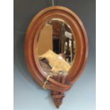 An early 20th century oak framed wall mirror with buckle design frame, 63 x 39cm