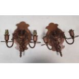 A pair of Arts & Crafts copper twin branch wall lights with dolphin supports and spiral turned