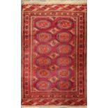 An early 20th century Tekke Turkman rug in a bold cochineal colour 180 x 114cm