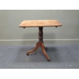 A 19th century tripod table, the rounded rectangular tilt-top over a turned column support raised on