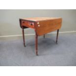 A Regency mahogany Pembroke table, with knob handles to end frieze drawer, on ring turned legs