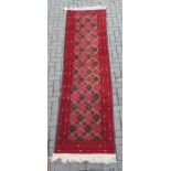 zzz A red ground runner together with a red ground rug with three medallions (2)
