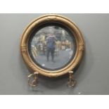 A regency gilt wood convex wall mirror with two scrolled candle sticks, 66cmPlease see