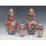 A pair of late 19th century lidded Imari vases 34cm high together with two smaller vases 16cm