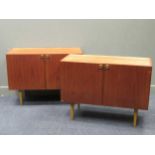 zzz A pair of Danish late 20th century two door side cabinets with metal handles and tapered legs (2