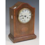 An Edwardian mahogany and banded mantel clock, bell striking movement 30cm high