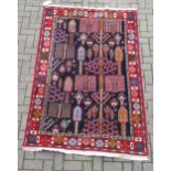 zzz A hand-woven blue ground rug with floral decoration