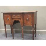 A small Regency mahogany breakfront sideboard raised on ring turned legs, 90 x 109 x 51cm