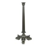 A Regency bronze table lamp, of tapering reeded columnar form to a tri-form base with three sphinx