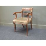 Two similar Regency mahogany dining armchairs, with scrolled arms and front sabre legs; together