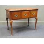 An 18th century style oak three drawer side table raised on cabriole legs and pad feet 70 x 87 x