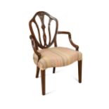 A late 19th century Hepplewhite style mahogany elbow chair with shield shaped back