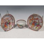 A Chinese Mandarin tea bowl and two matching saucers, Qianlong, late 18th century, decorated with