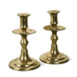 A pair of brass candlesticks, 17th century,