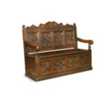 A later carved oak box-seated settle, 19th century,