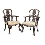 A pair of Chippendale style mahogany ribbon backed elbow chairs, 20th century,