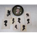 A group of late 20th century side profile silhouettes together with a circular glass framed portrait