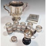 Two silver two handled trophy cups together with a small silver table cigarette box, a small round