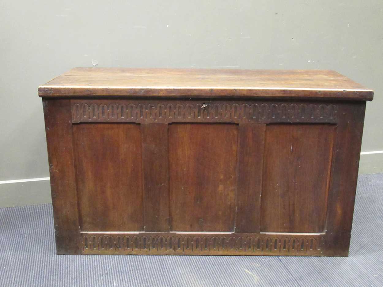 A large oak coffer in the 17th century style with nulled carved frieze and three panel front and - Image 7 of 7