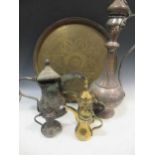 Various Middle Eastern metalwares to include coffee pots and a circular tray, 57cm diameter