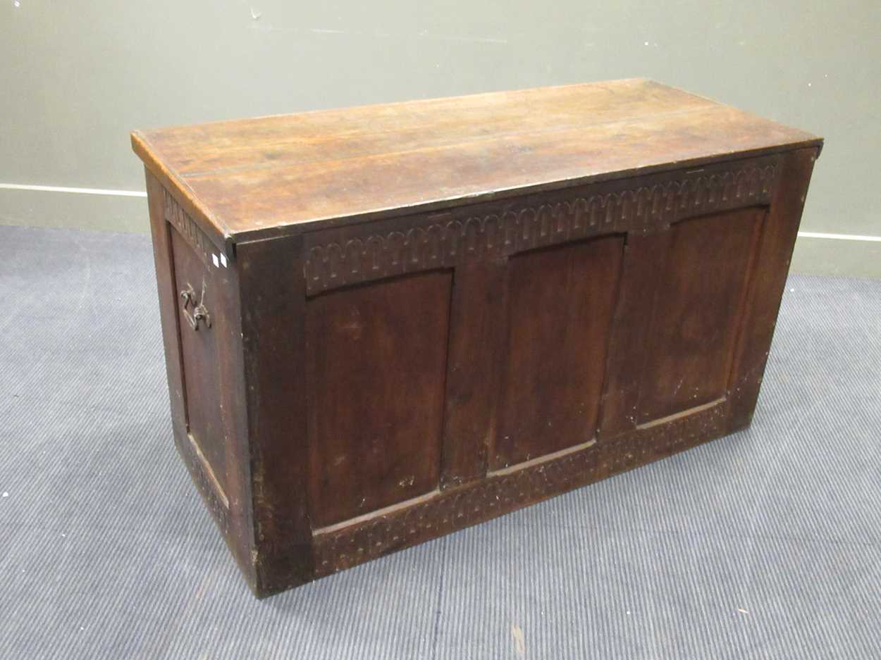 A large oak coffer in the 17th century style with nulled carved frieze and three panel front and - Image 5 of 7