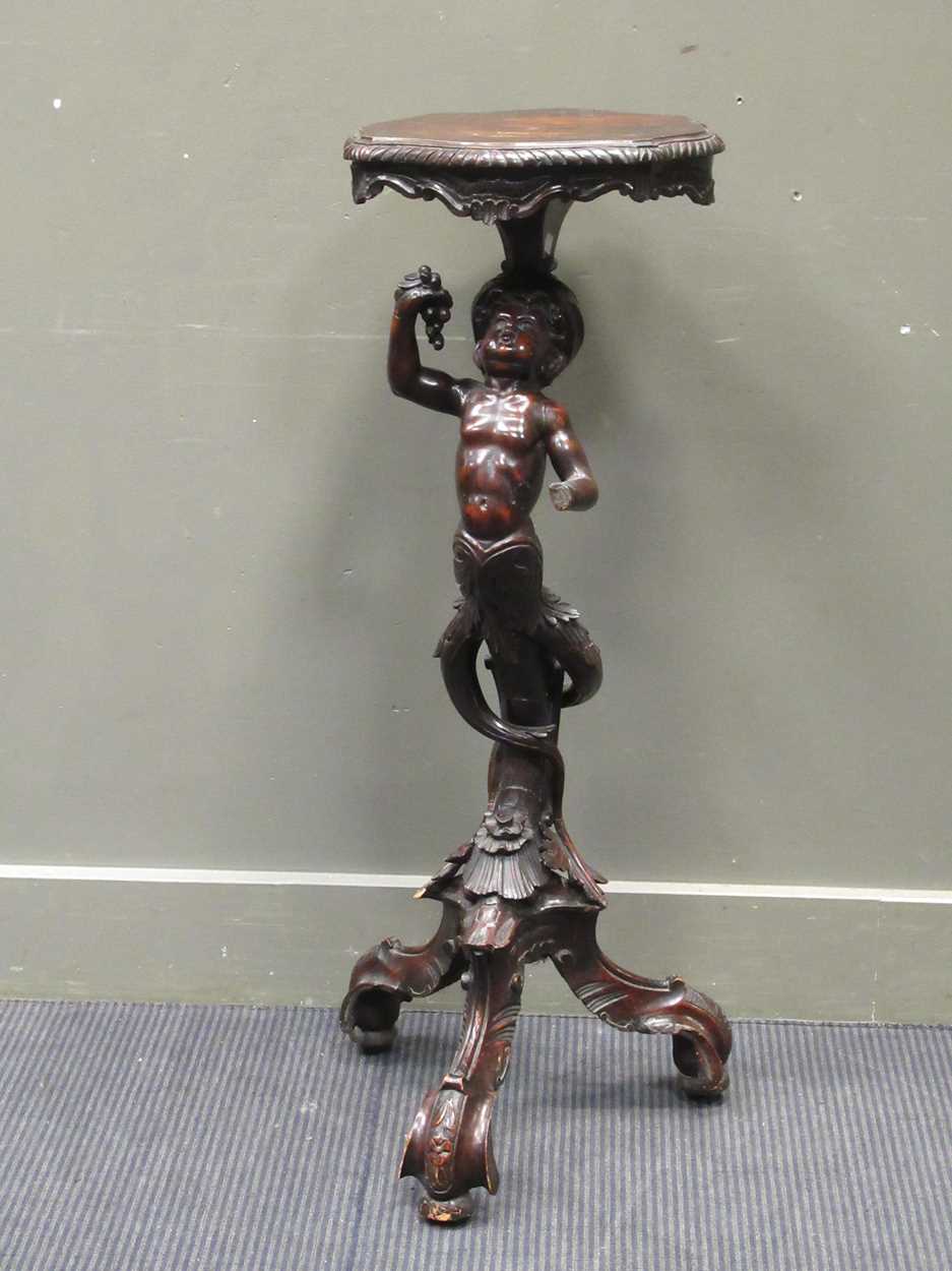A 19th century carved figural pedestal, the scallop shaped top over a figural pedestal of a boy