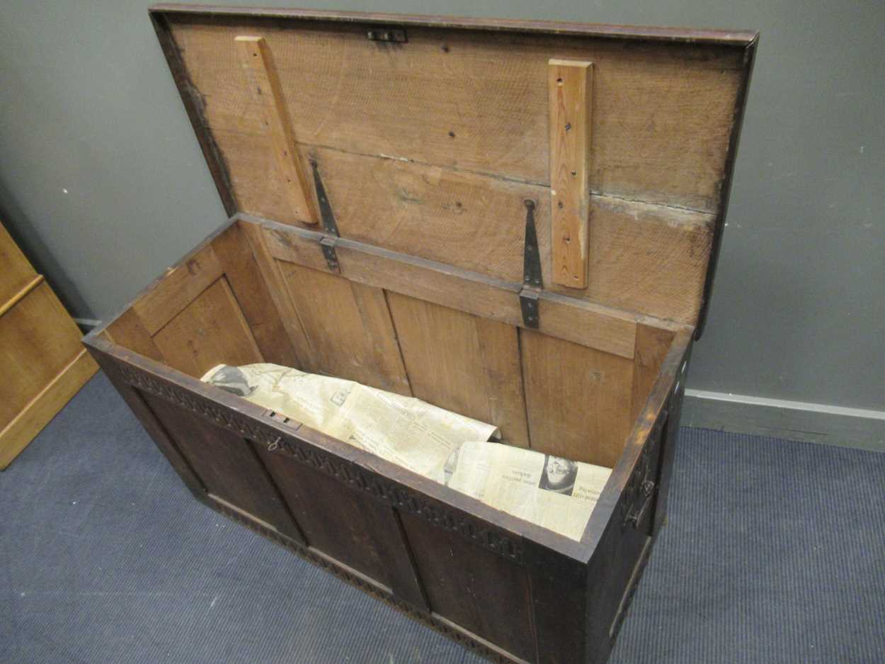 A large oak coffer in the 17th century style with nulled carved frieze and three panel front and - Image 6 of 7