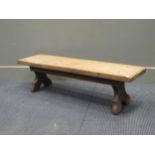 A Jack Grimble Cromer oak stool, the rectangular stool with chip carved ends on shaped supports, one