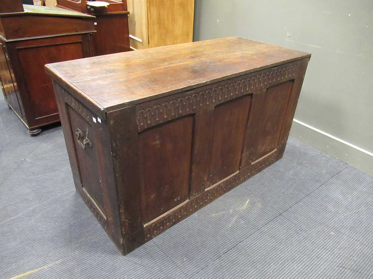 A large oak coffer in the 17th century style with nulled carved frieze and three panel front and - Image 4 of 7