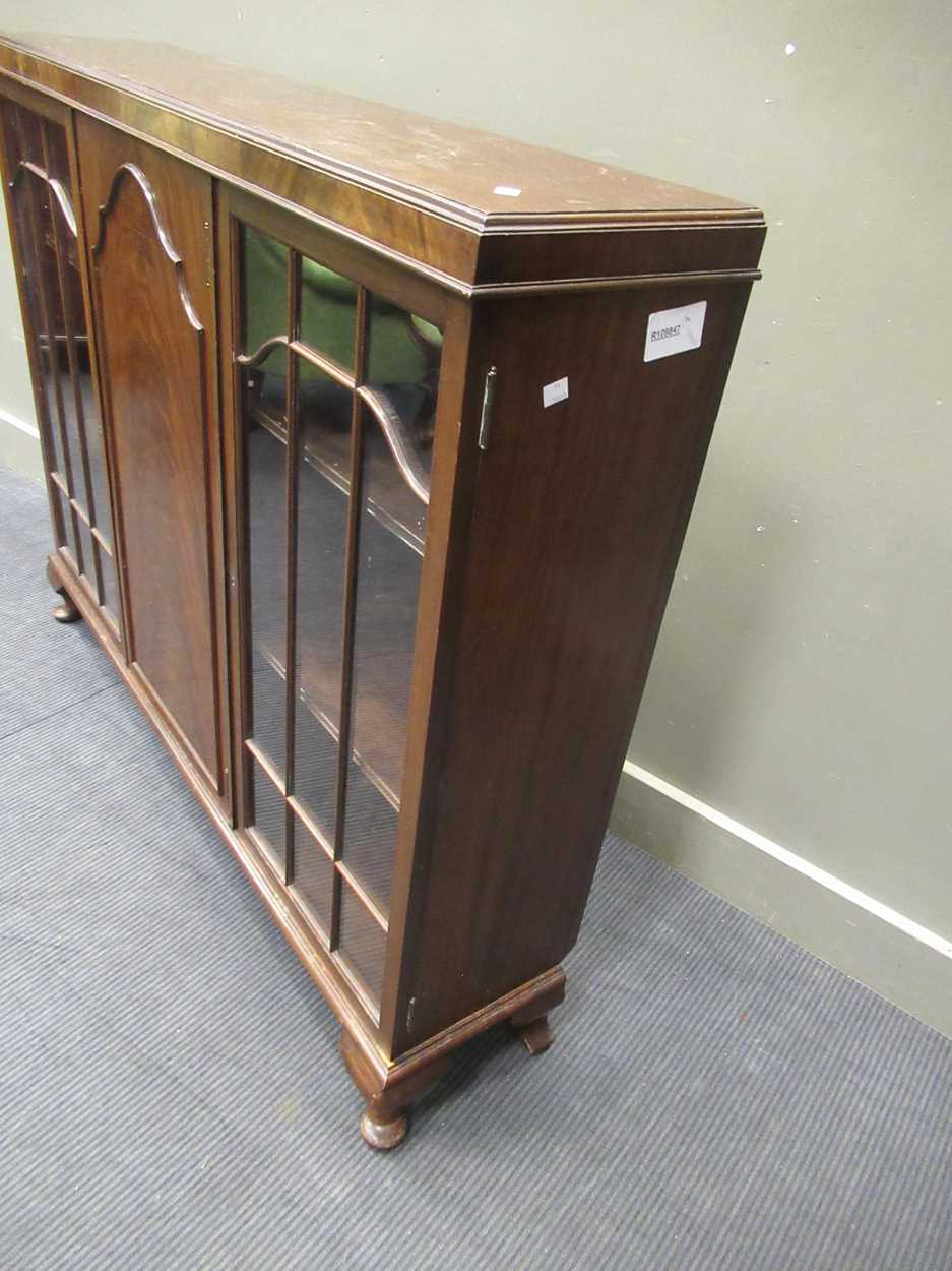 A 1920s mahogany low bookcase cabinet with central cupboard door flanked by a pair of glazed - Image 4 of 5