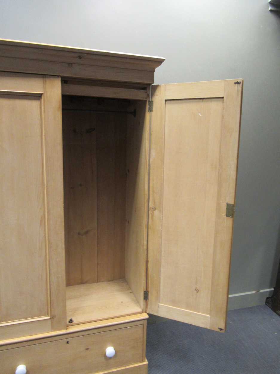 An early 20th century pine two-door wardrobe with drawer to base 207 x 114 x 58cm - Image 2 of 3