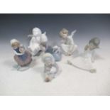 A collection of Lladro figures to include a Inuit child with a polar bear, a girl with a basket of