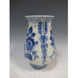 A blue and white Delft tulip vase with flared rim and ribbed sides, decorated with floral swags,