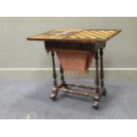 A 19th century inlaid rosewood games table, the fold over swivel top enclosing an inlaid