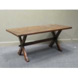 An oak trestle table, the rectangular top on twin X-shaped supports united by a stretcher, 74 x