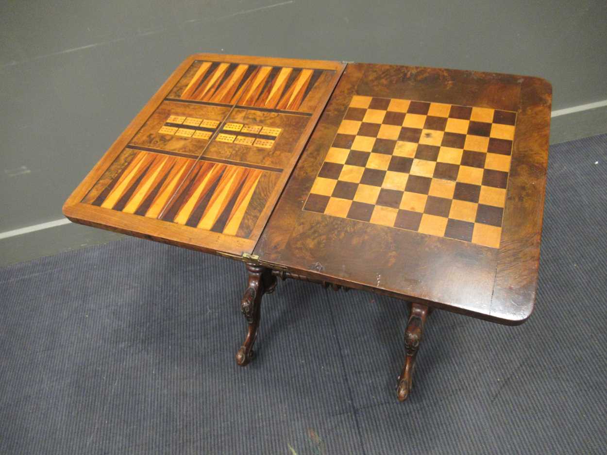 A Victorian walnut inlaid fold over games table, the fold over top enclosing an inlaid backgammon - Image 5 of 7