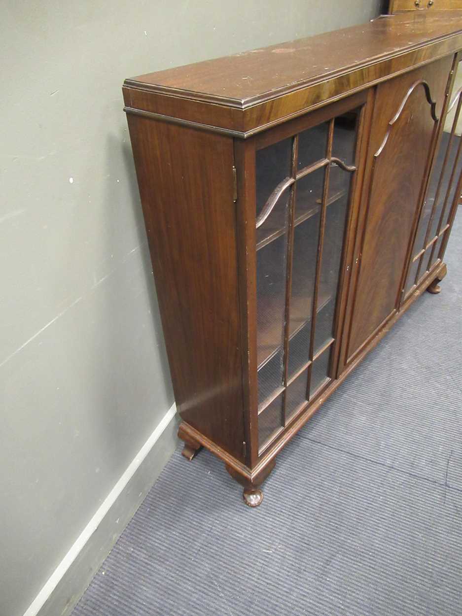 A 1920s mahogany low bookcase cabinet with central cupboard door flanked by a pair of glazed - Image 5 of 5