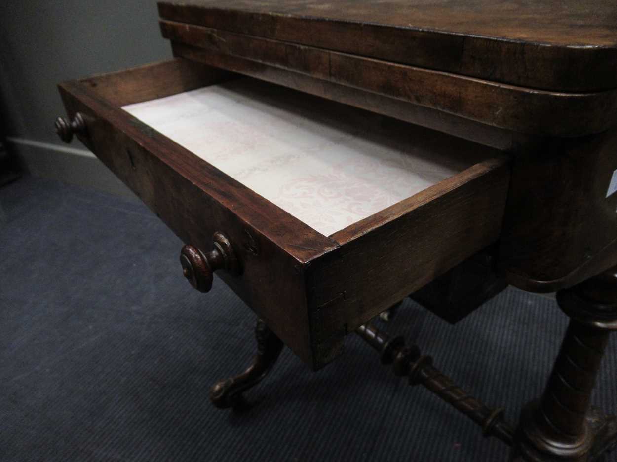 A Victorian walnut inlaid fold over games table, the fold over top enclosing an inlaid backgammon - Image 2 of 7