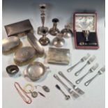 A collection of silver including flatware, cased egg cup and spoon, 2 1/2 pairs of loaded