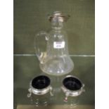 A silver topped glass claret jug; together with a pair of silver cauldron salts (3)