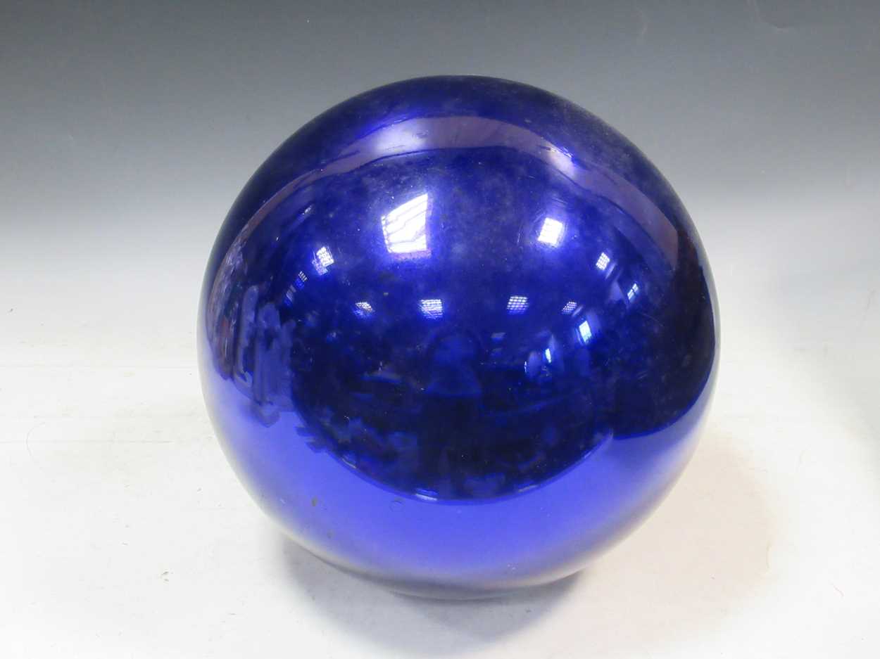 A large late 19th or early 20th century blue glass Witch's ball, approx 30cm diameterSome movement