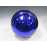 A large late 19th or early 20th century blue glass Witch's ball, approx 30cm diameterSome movement