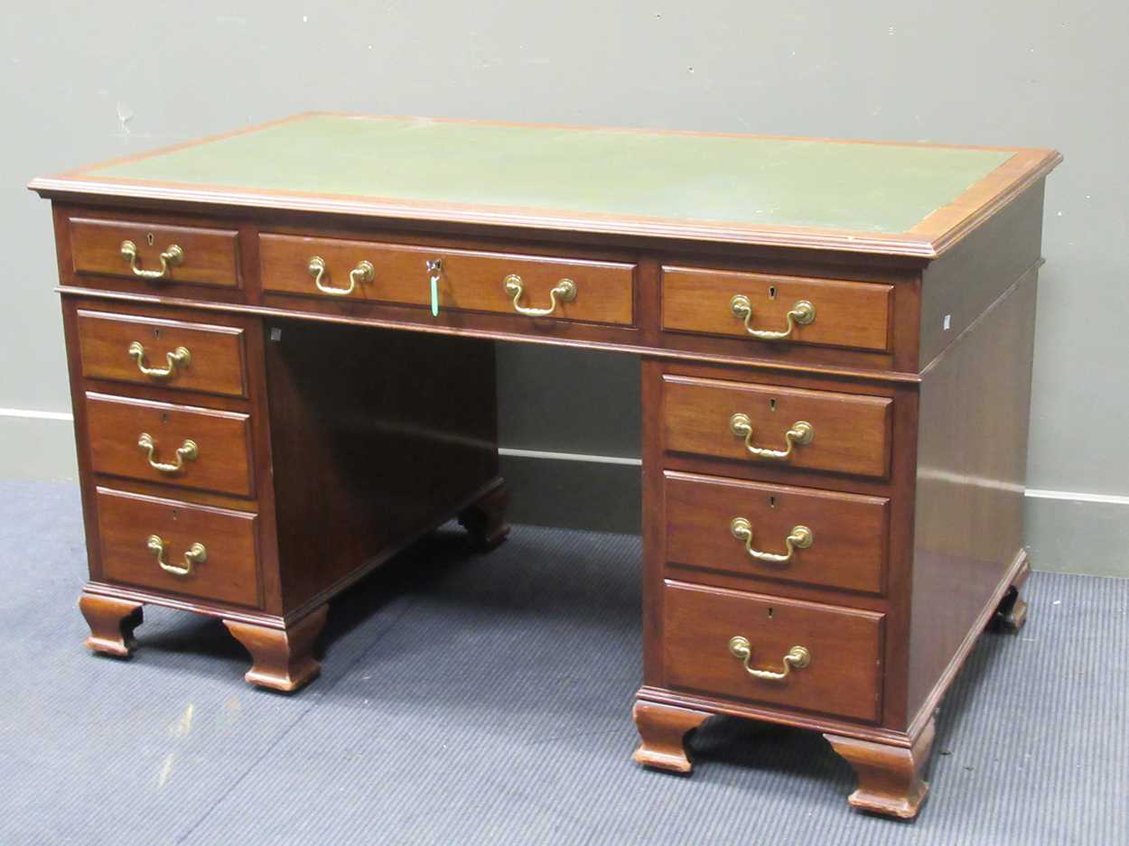 A George III style mahogany pedestal desk comprising of nine drawers on ogee bracket feet, 78 x