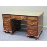 A George III style mahogany pedestal desk comprising of nine drawers on ogee bracket feet, 78 x