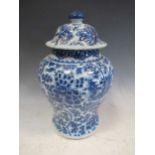 A blue and white lidded jar, in Kangxi style, decorated with a mythical bird, 34cm highChipping