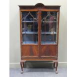 A glazed mahogany cabinet with cabriole legs and claw feet, 186 x 106 x 38cmProperty from Blomvyle