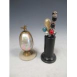 A late 19th century French table etui, the mother of pearl egg form body in gilt metal mount with