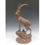 A black forest carved wooden model of an Ibex, 67cm highSome loss to the horns and ear with