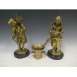 A pair brass figures possibly continental largest 32cm high and an 18th century pestle and mortar (