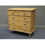 A late Victorian pine chest of drawers, comprising of two short over three long drawers on turned